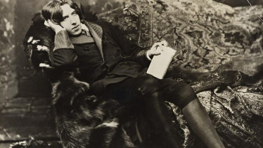 Photograph of Oscar Wilde reclining.