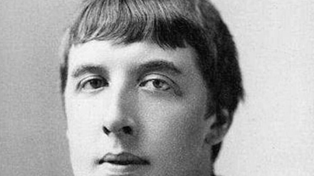 Headshot of Oscar Wilde with cropped hairstyle that mimics Nero's.