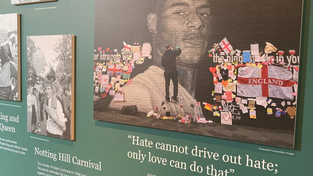 A close-up photo of the Black History Month gallery which focuses on an image of a graffiti artist working on a giant mural of Marcus Rashford.