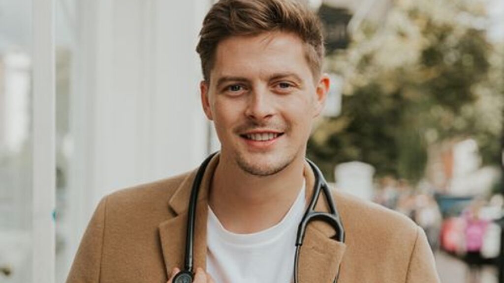 Headshot of Dr Alex George with a stethoscope around his neck