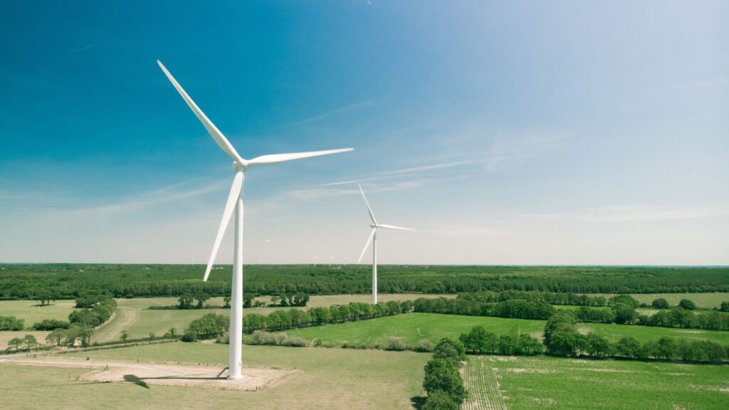 Two wind turbines in a green field