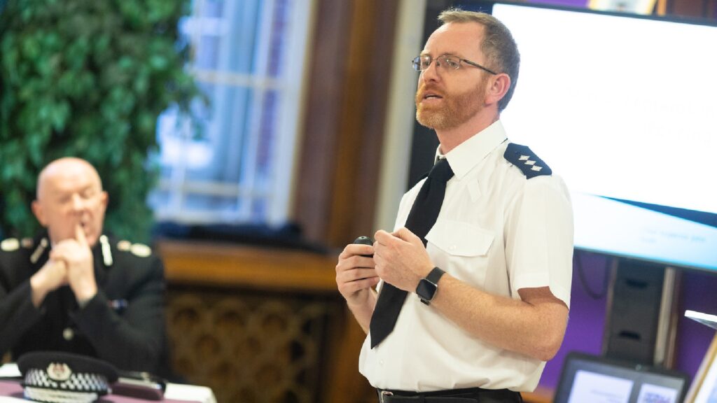 Police officer giving a speech at an on campus awards ceremony