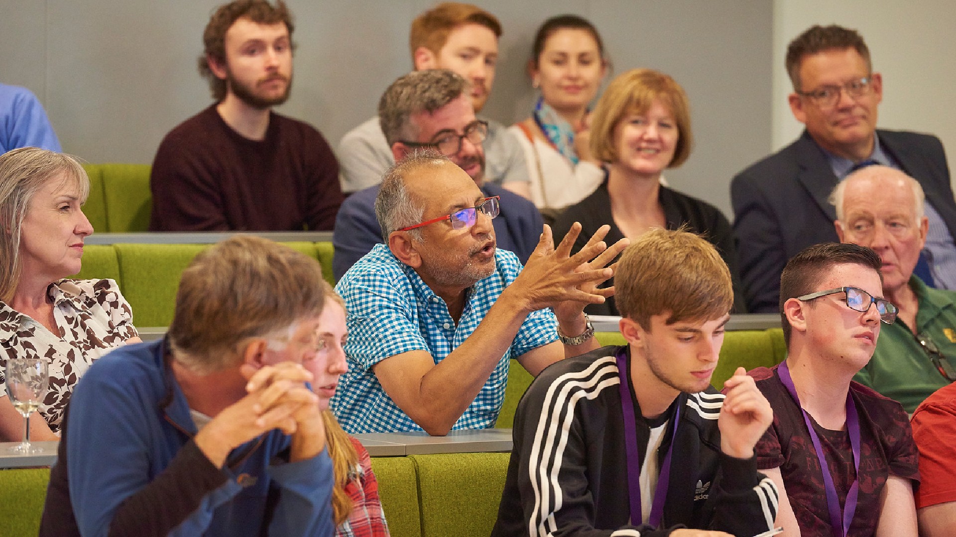 A group of researchers talking and listening to a lecture