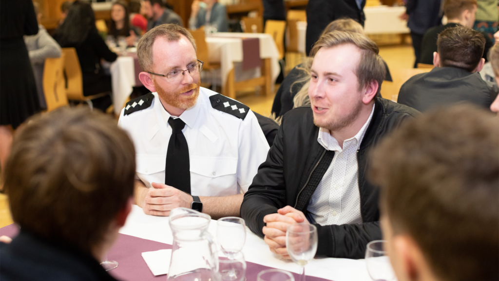 Professionals and students sat at table at the EHU Police Awards