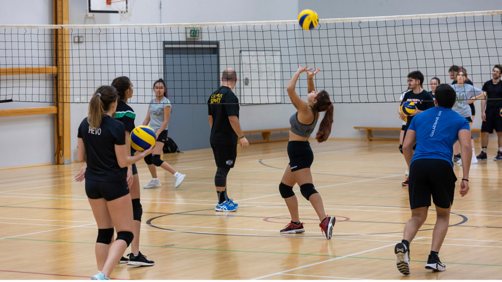 A group of students play volleyball