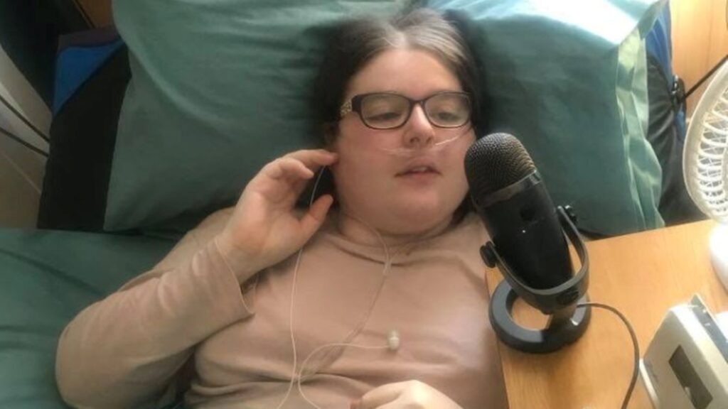 Kara Jane recording a podcast from her bed