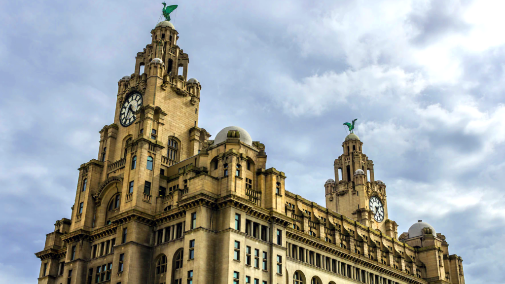 A low angle shot of one of the towers of the Royal Liver Buildings in Liverpool.  It is taken on a clear day of blue skies and white clouds.