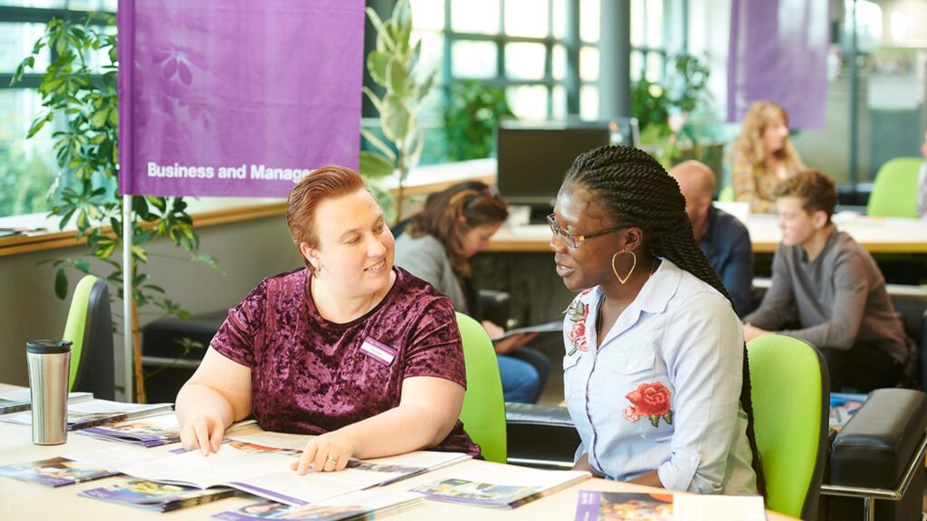 A student chats to a member of staff about a Business course at an Edge Hill offer holder day