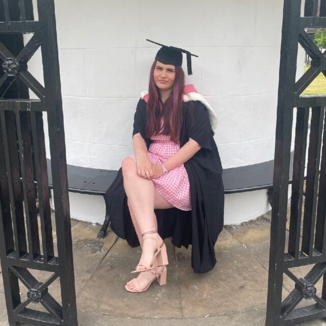 Secondary Geography with QTS (11-16) student, Annabelle Hawley, wearing graduation robes and a mortar board