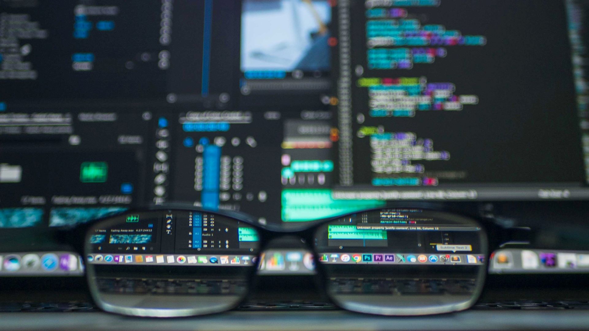 A picture of a pair of glasses in front of a computer screen.