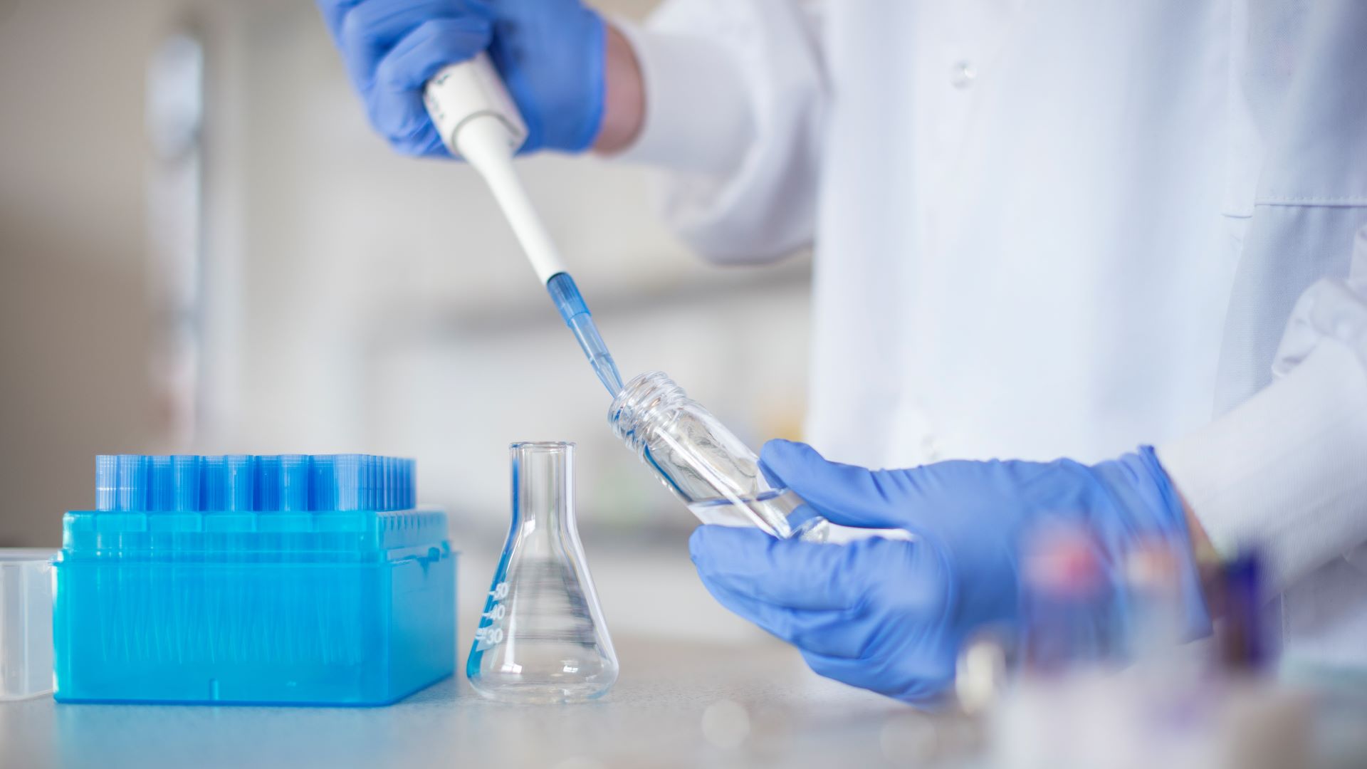 A person takes samples in a laboratory