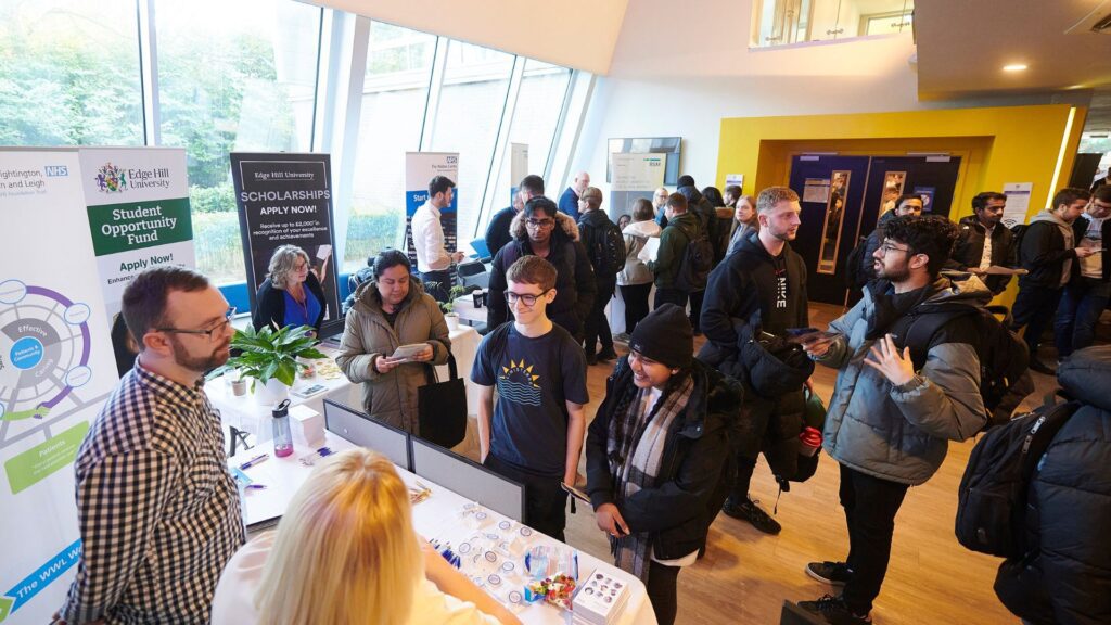 group of students and exhibitors at a busy computer science careers fair in the tech hub