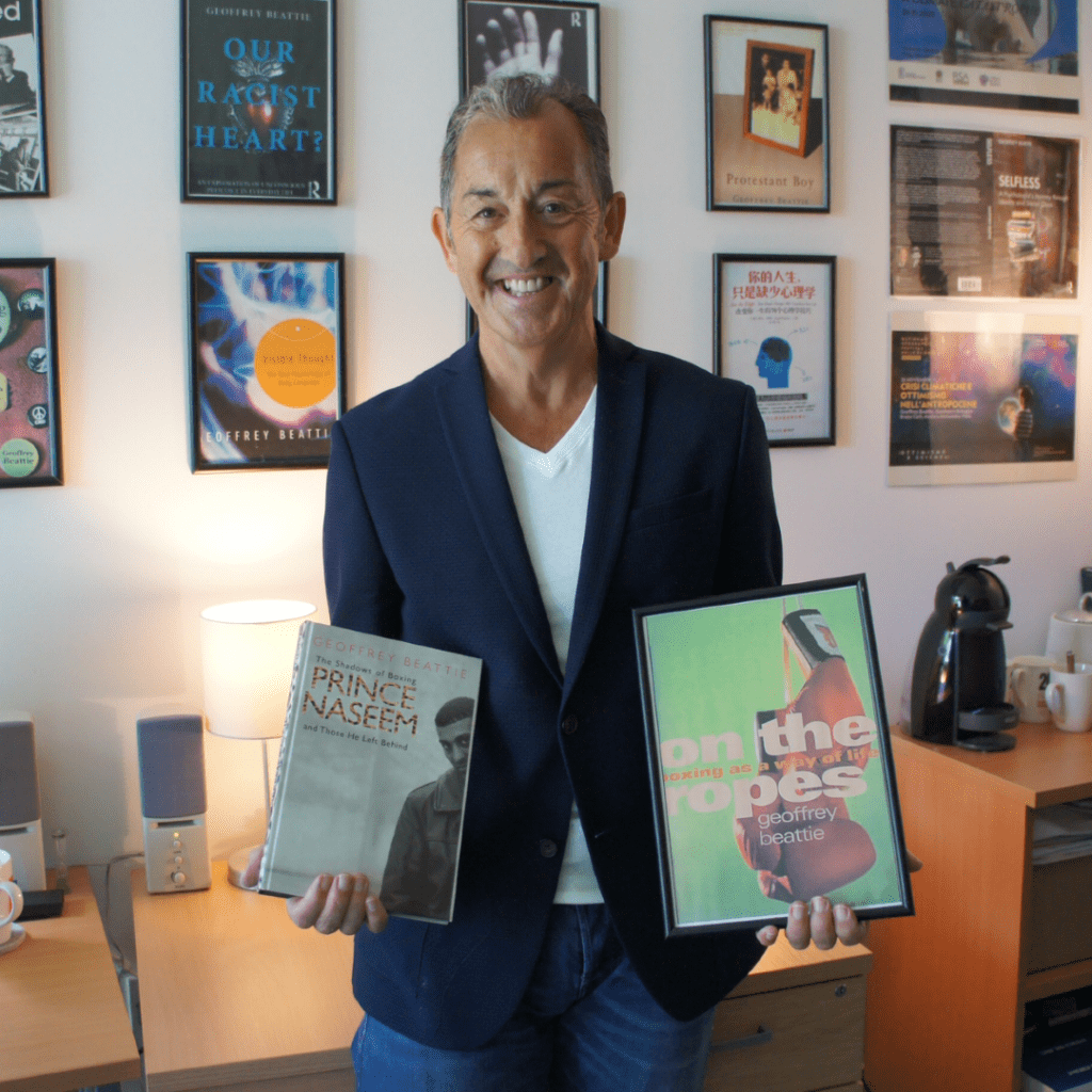 Professor Geoff Beattie holding two of his books.