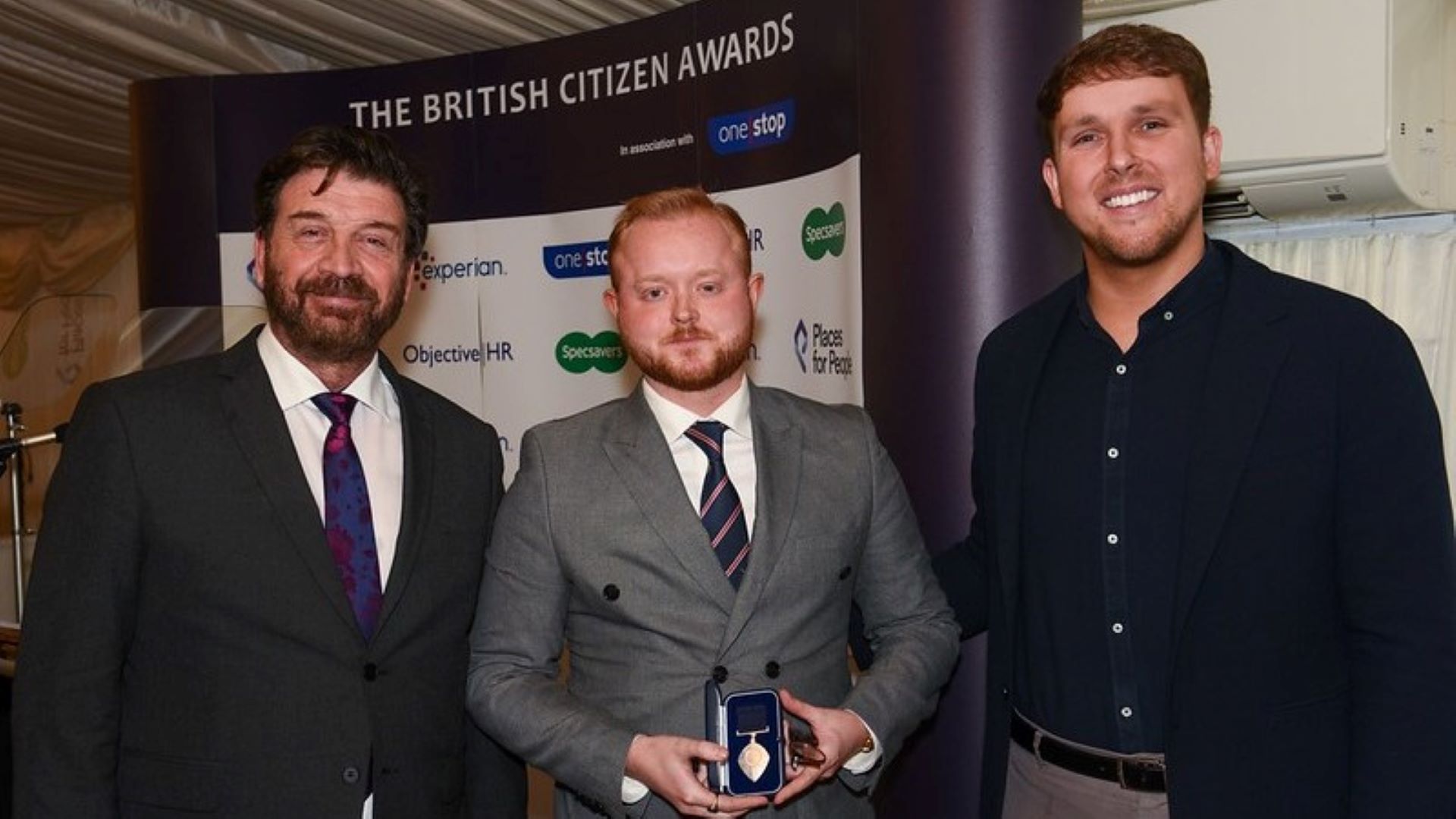 A picture of Travis Frain next to Nick Knowles receiving his British Citizen Award.