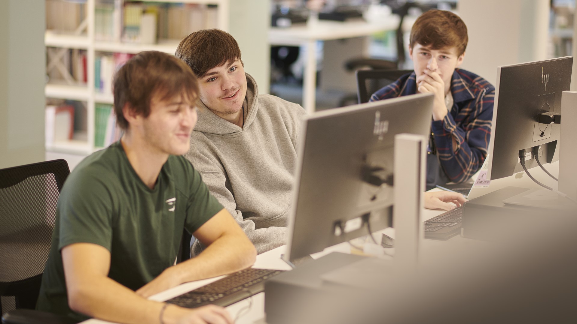 Three students gather around a computer. Edge Hill University in Lancashire has chosen PebblePad to deliver an institution-wide employability programme, centred around a powerful Graduate Attributes Workbook.