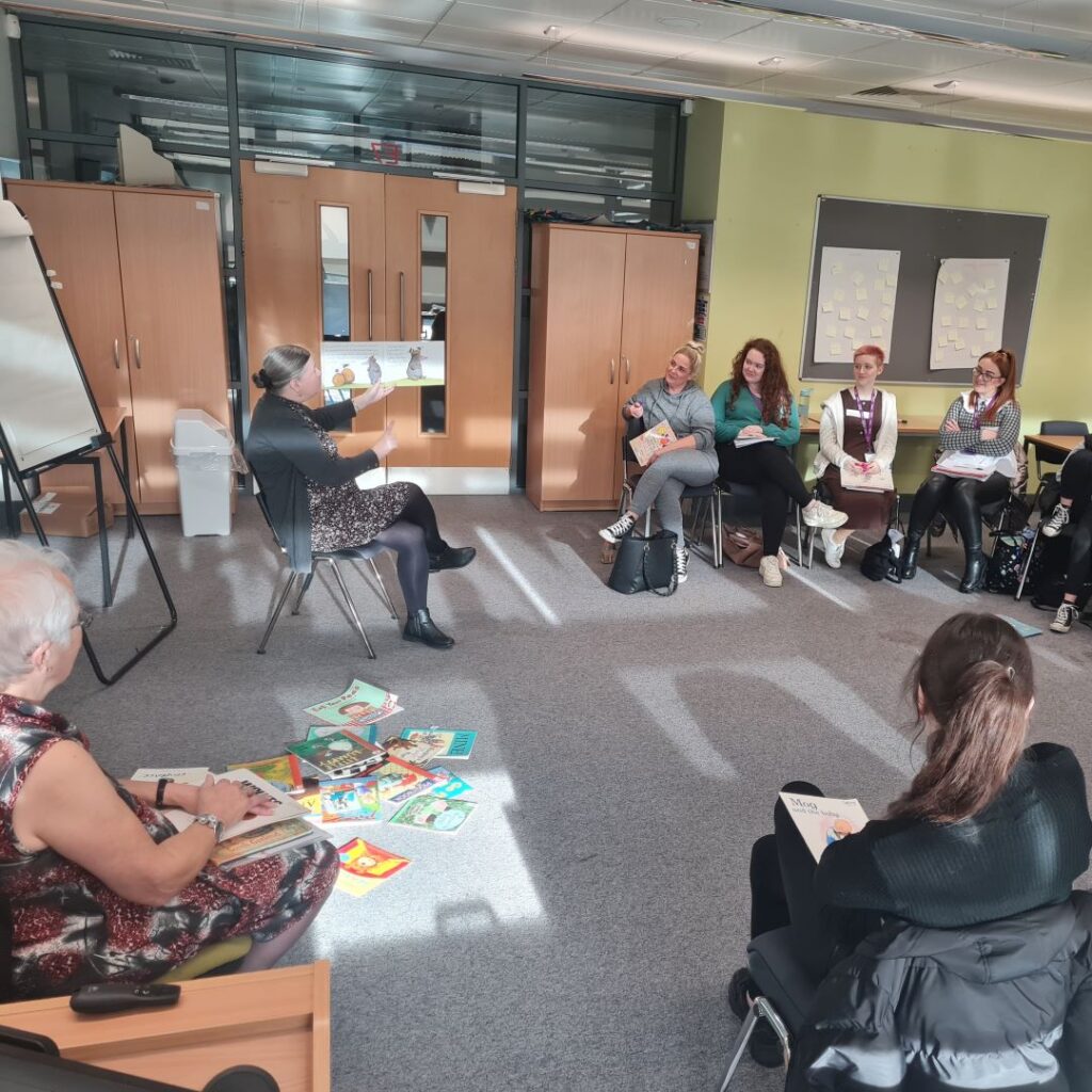 A picture of students being shown a children's book.