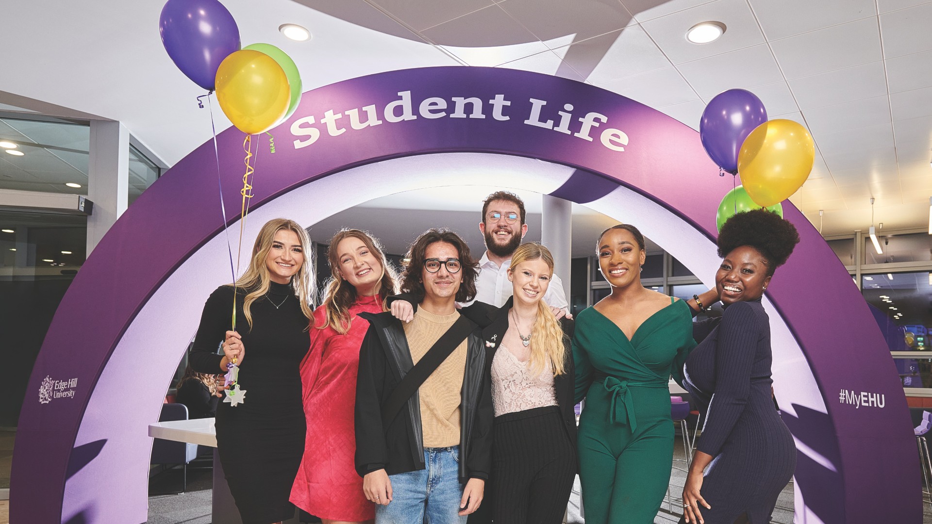 A group of students stood together holding up their scholarship award certificate