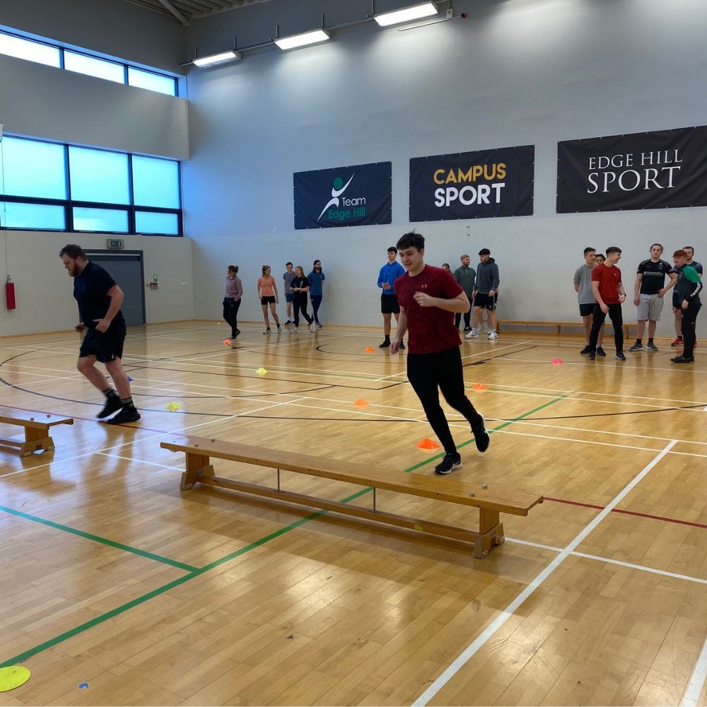 students in sports hall taking part in multi skills session