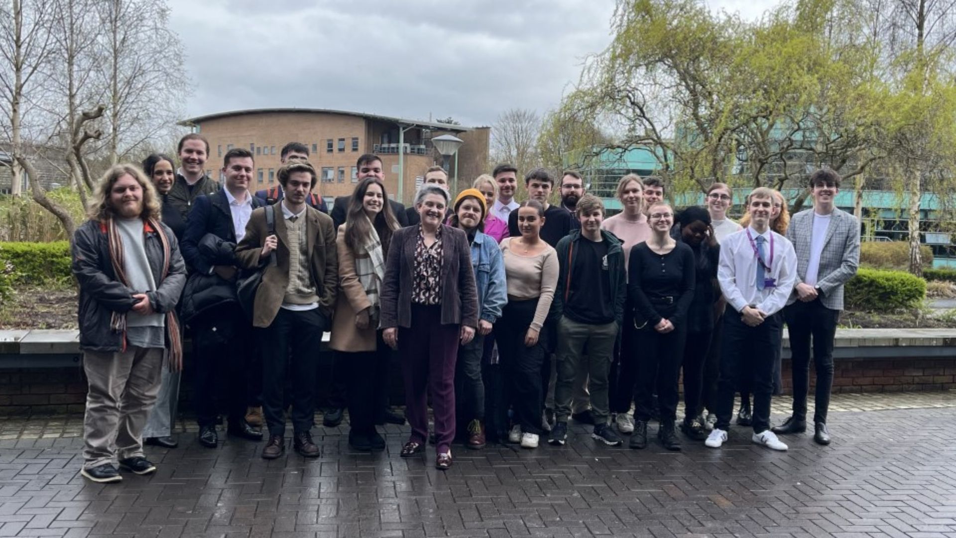 politics students stood outside on campus with Ashley Dalton MP