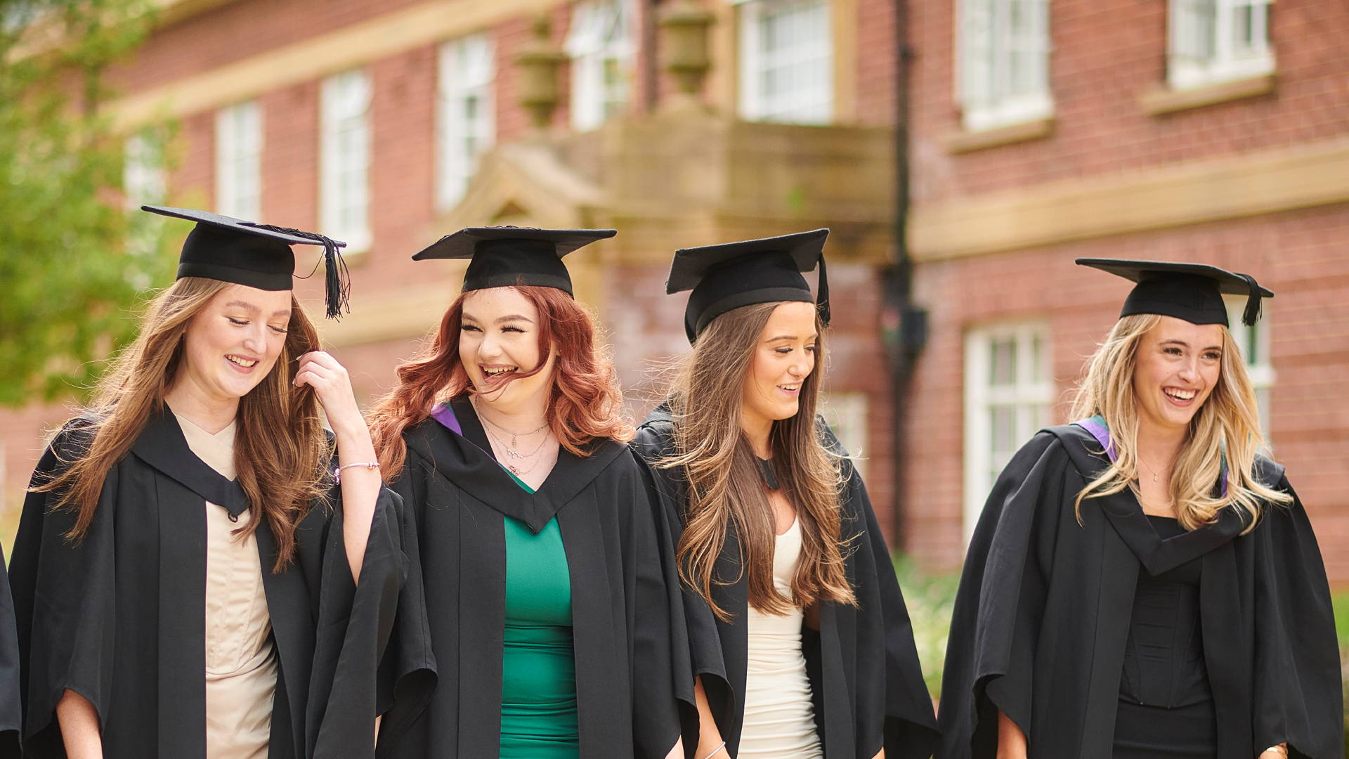 four female students at graduation