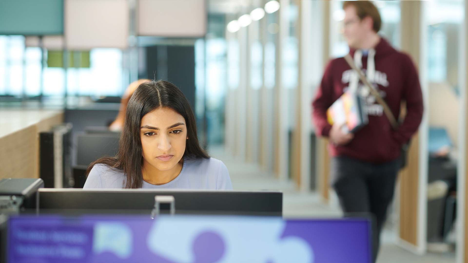 female student working on a laptop in catalyst