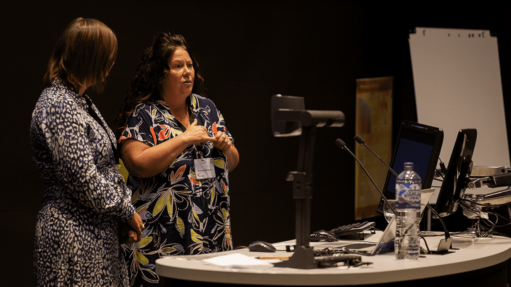 Two speakers in a lecture theatre at the ACRE 2022 Transitions and Transformations event