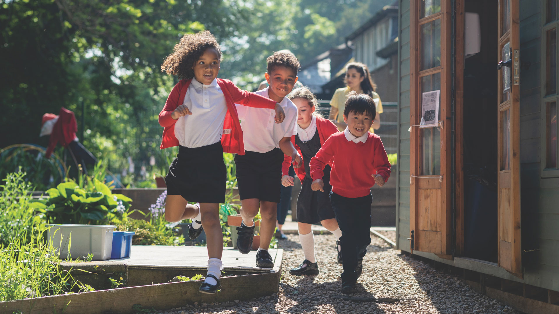 A group of school children running and smiling