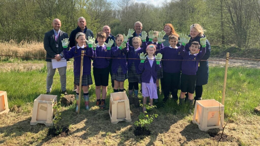 A picture of children planting trees.