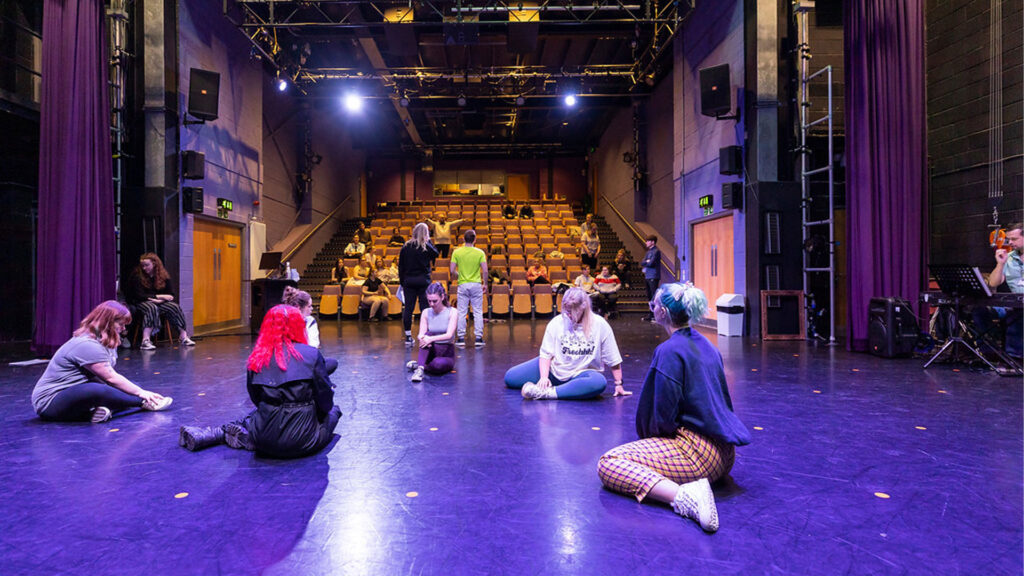 Students practice on the stage of The Studio Theatre