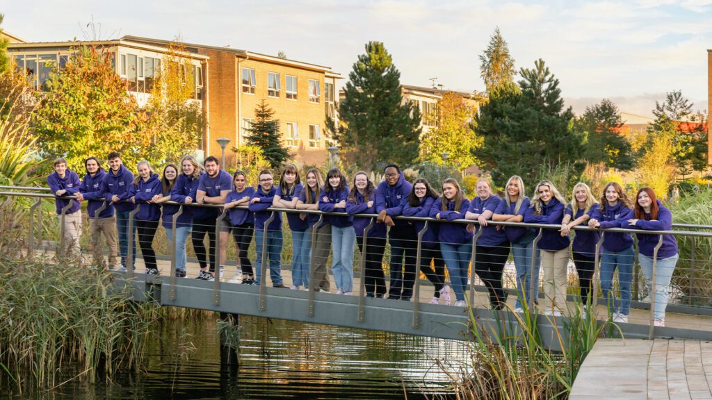 Campus Connectors stood in a line on the bridge over the eastern lake