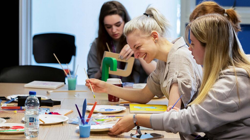 students doing arts and crafts on campus