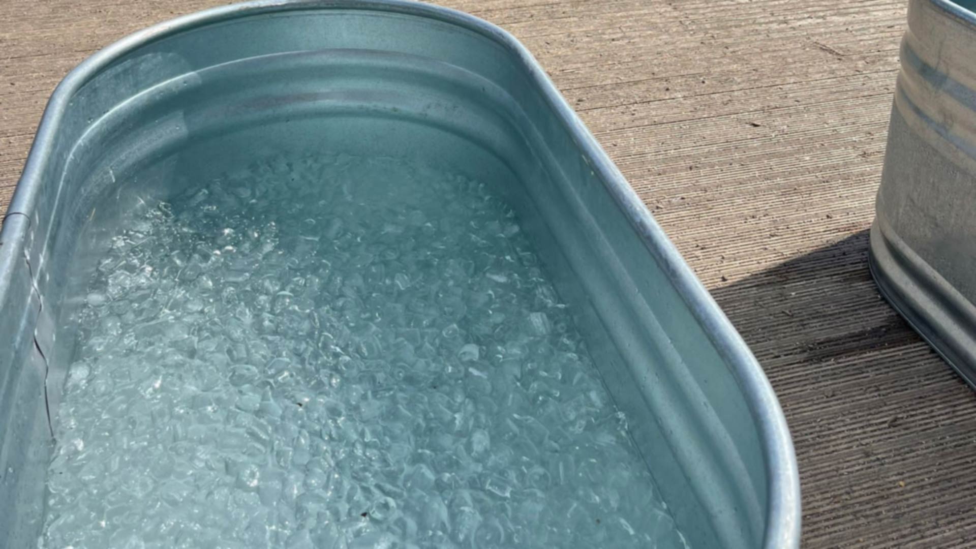 close up of a mental ice bath filled with ice cubes and water