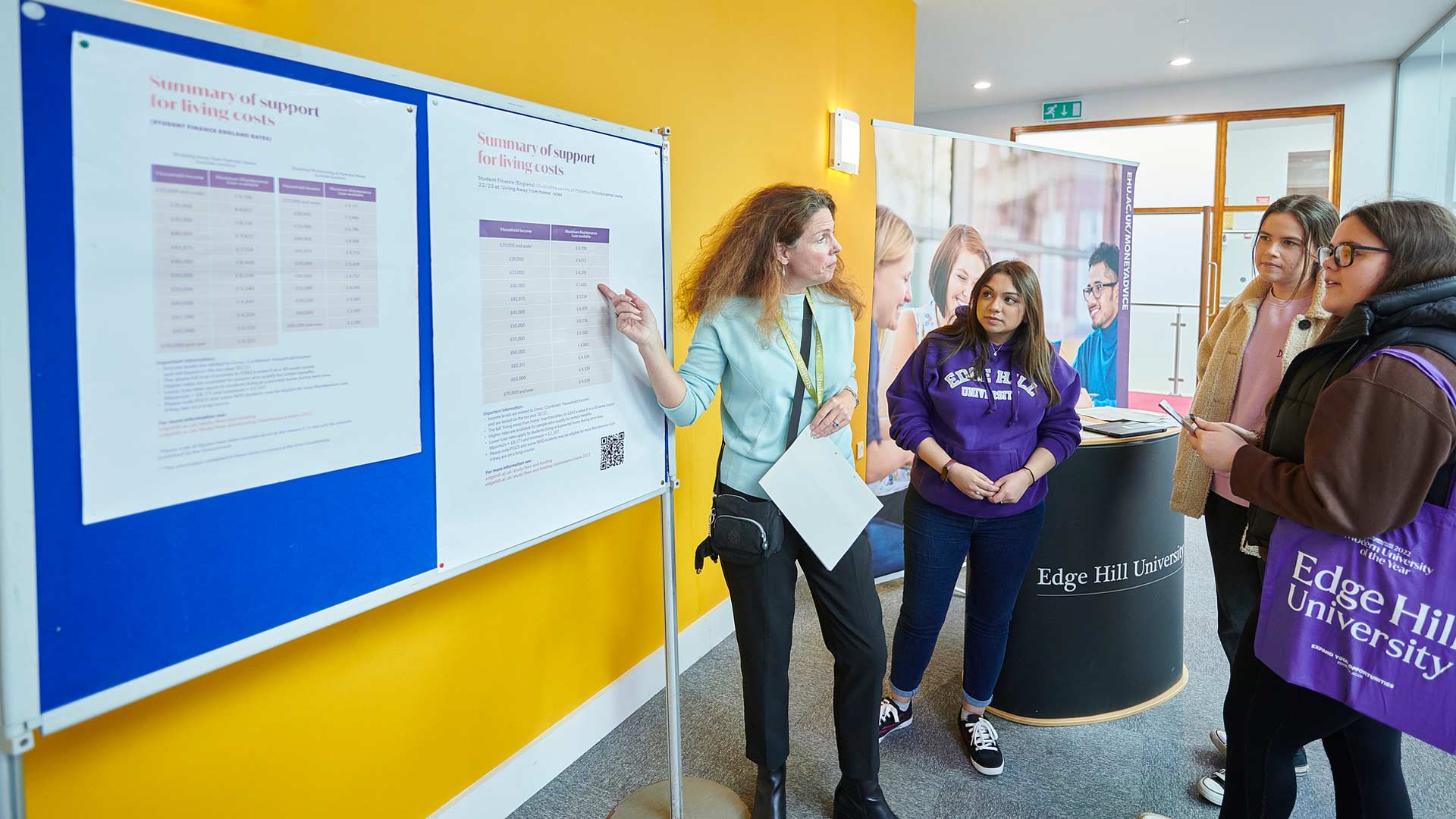 Prospective students getting help from a member of staff from the Money Advice Team.