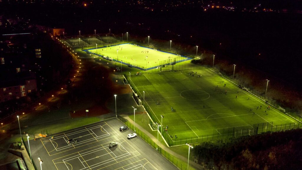 Edge Hill football pitches lit up at night.