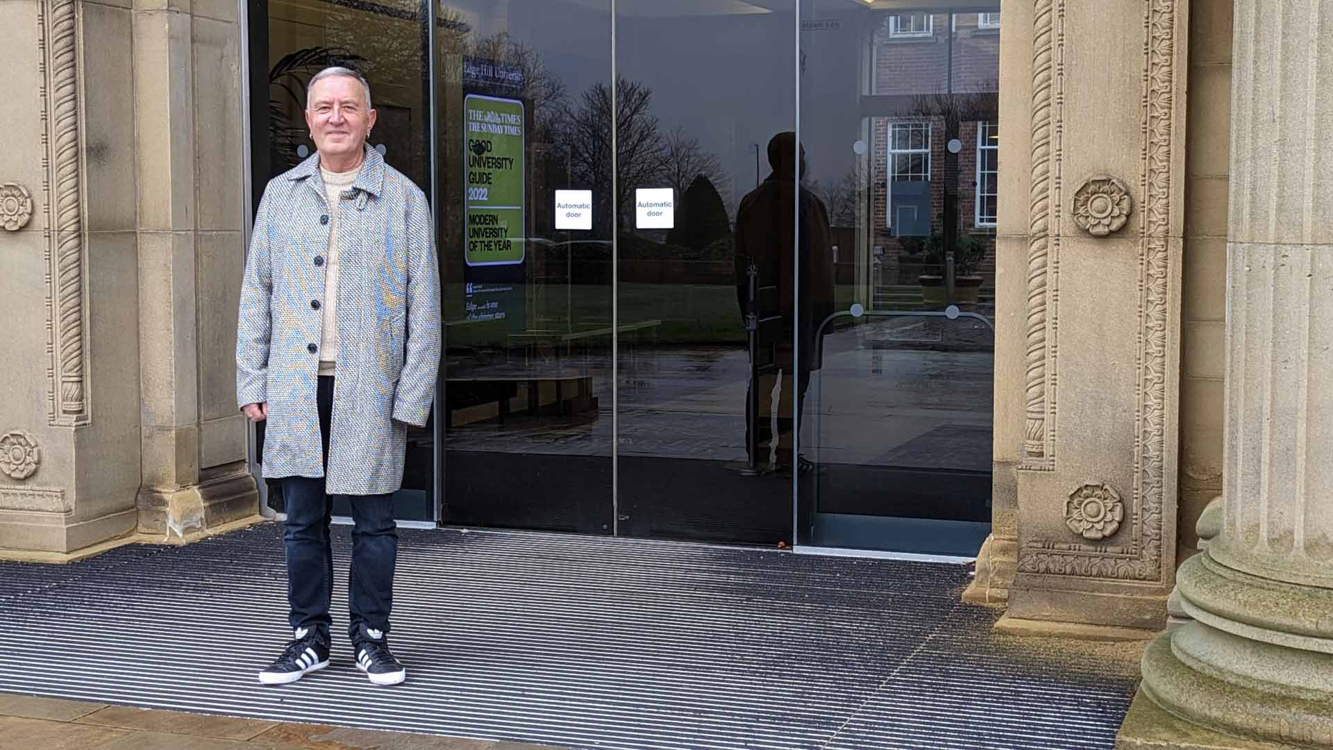 A photo of Tony Daley outside the Main Building at Edge Hill University.