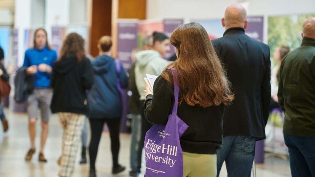 Students attending an open day at edge hill university hub carrying their gift bags
