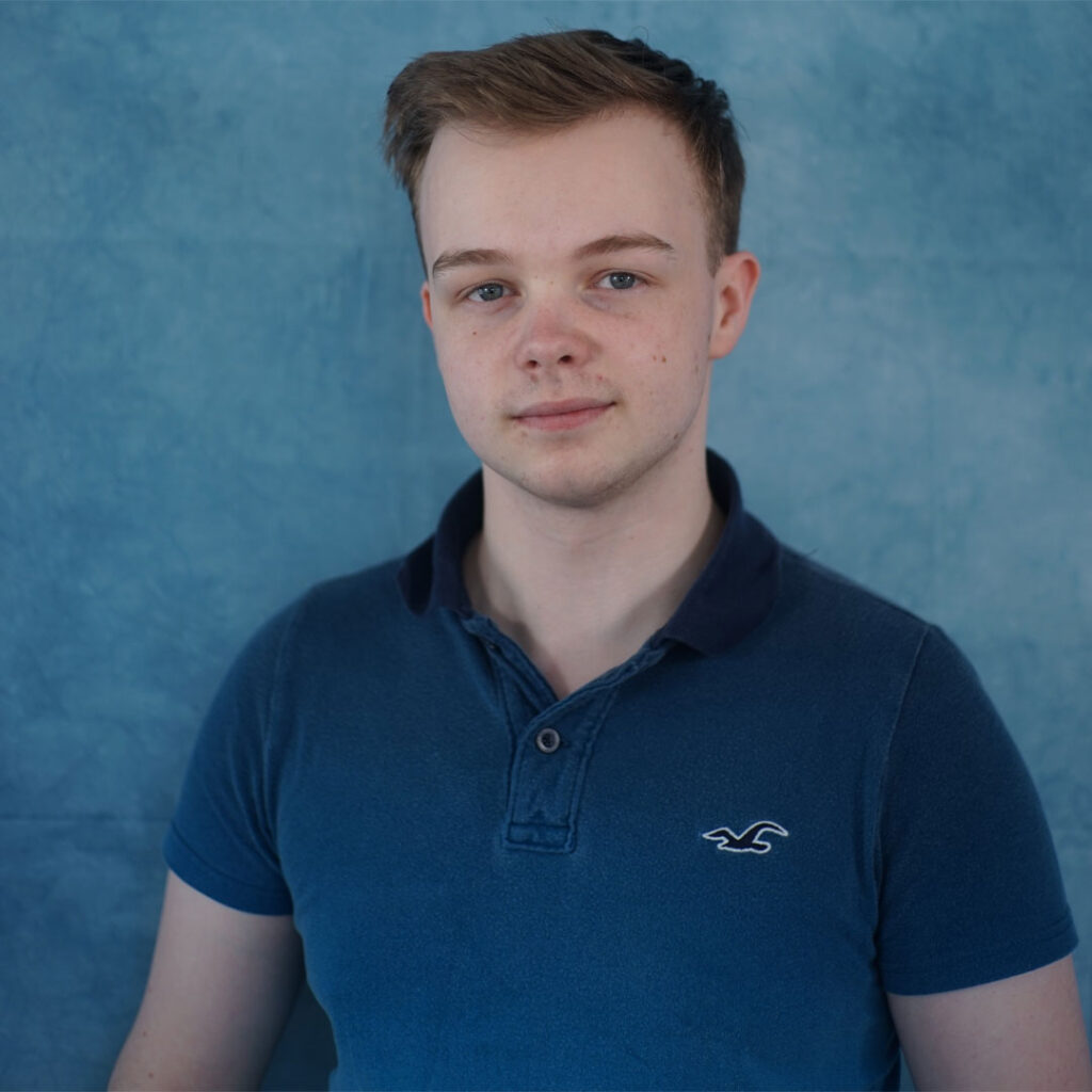Image of Computer Science student, Alexander. With a blue background