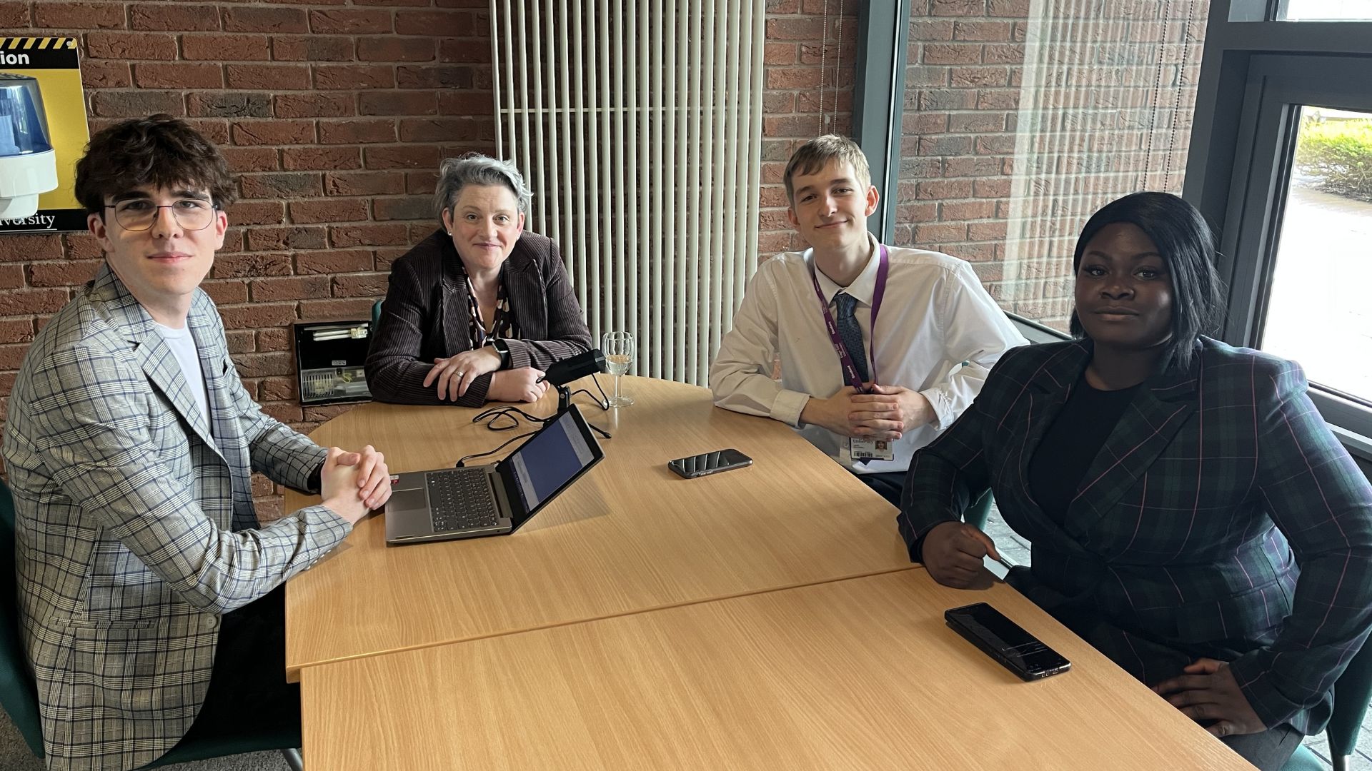 students interviewing mp ashley dalton around a table