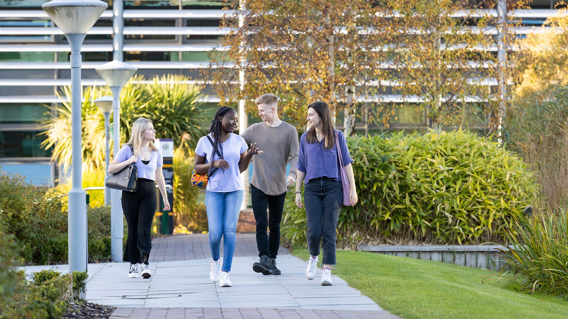 A group of students walk near the Faculty of Health