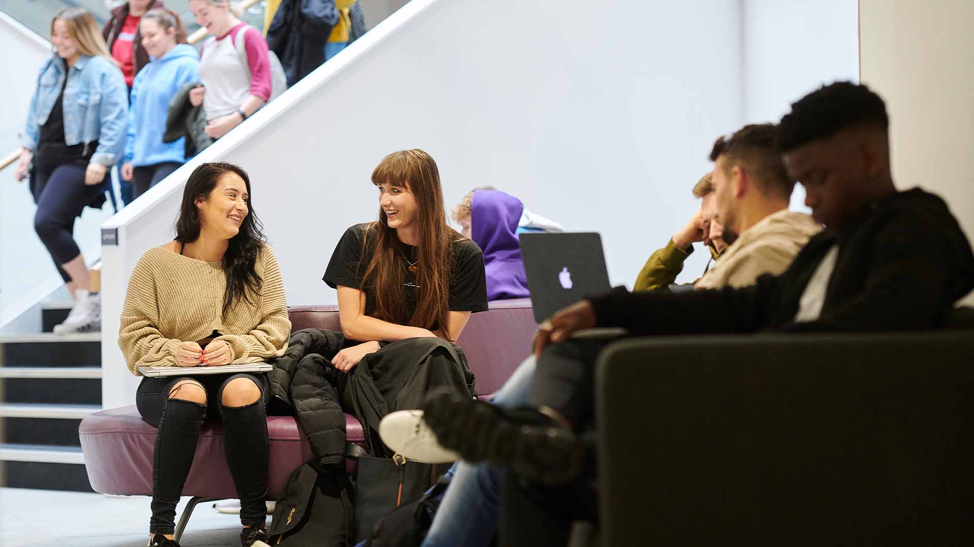 Students in the Law and Psychology building foyer waiting to go into their lecture or class.