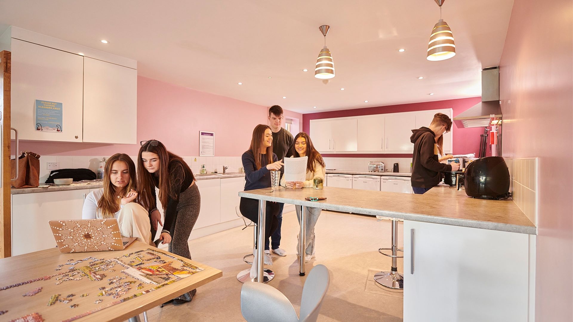 Students socialising in their kitchen.