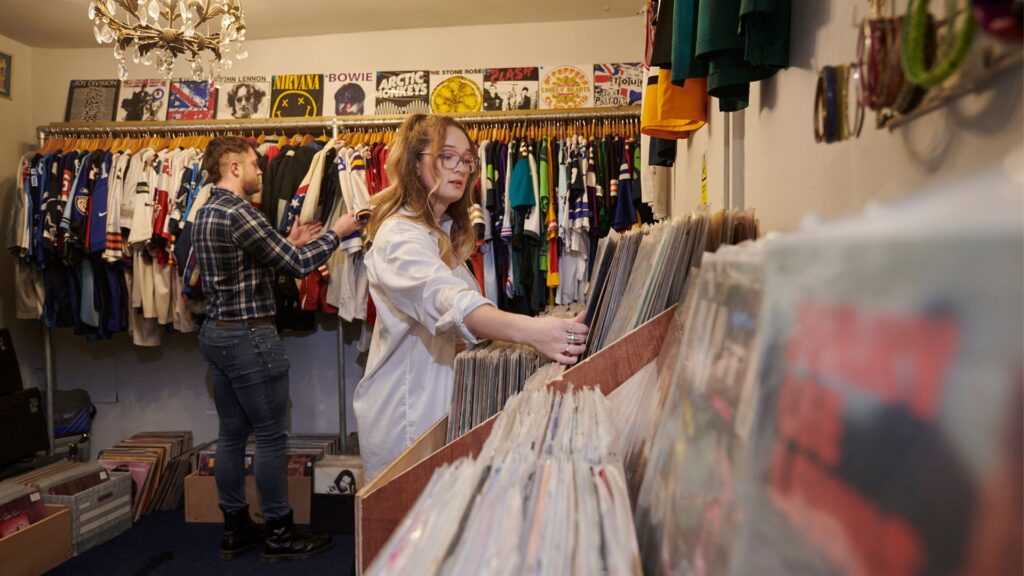 Students browse the clothing and records at a local vintage shop