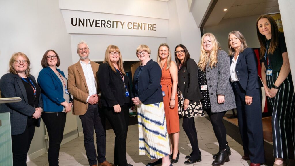 A picture of 10 Edge Hill and Burnley College staff stood in a line.