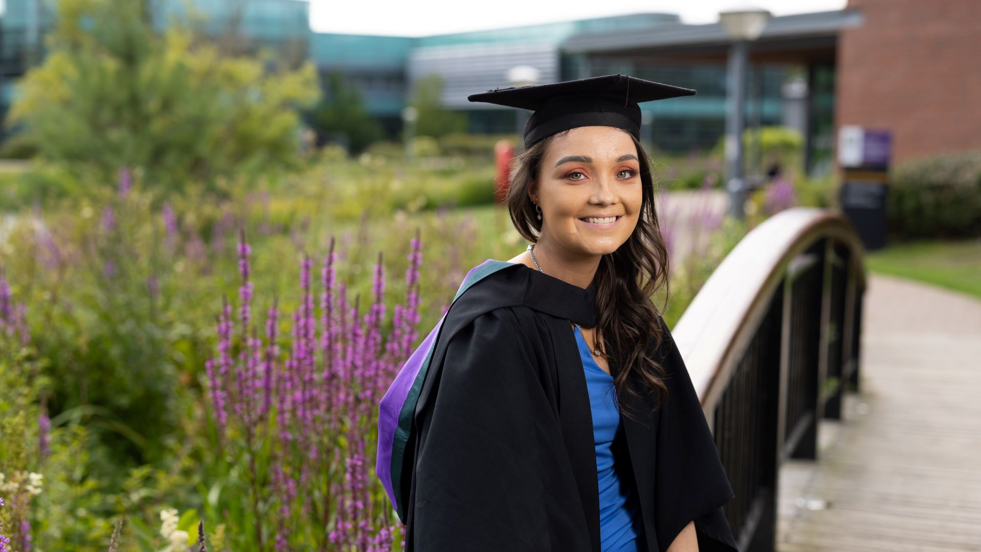 A picture of Chloe McDougall in a graduates cap and gown.