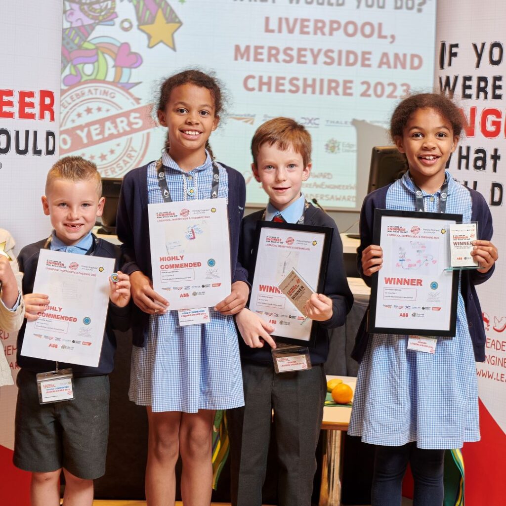 Four children holding up their awards. 