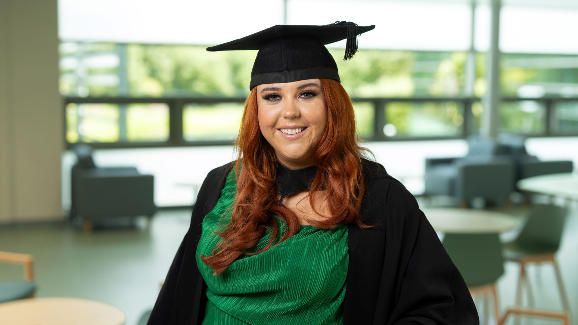 A picture of Eleanor Hyland in a gradate cap and gown.