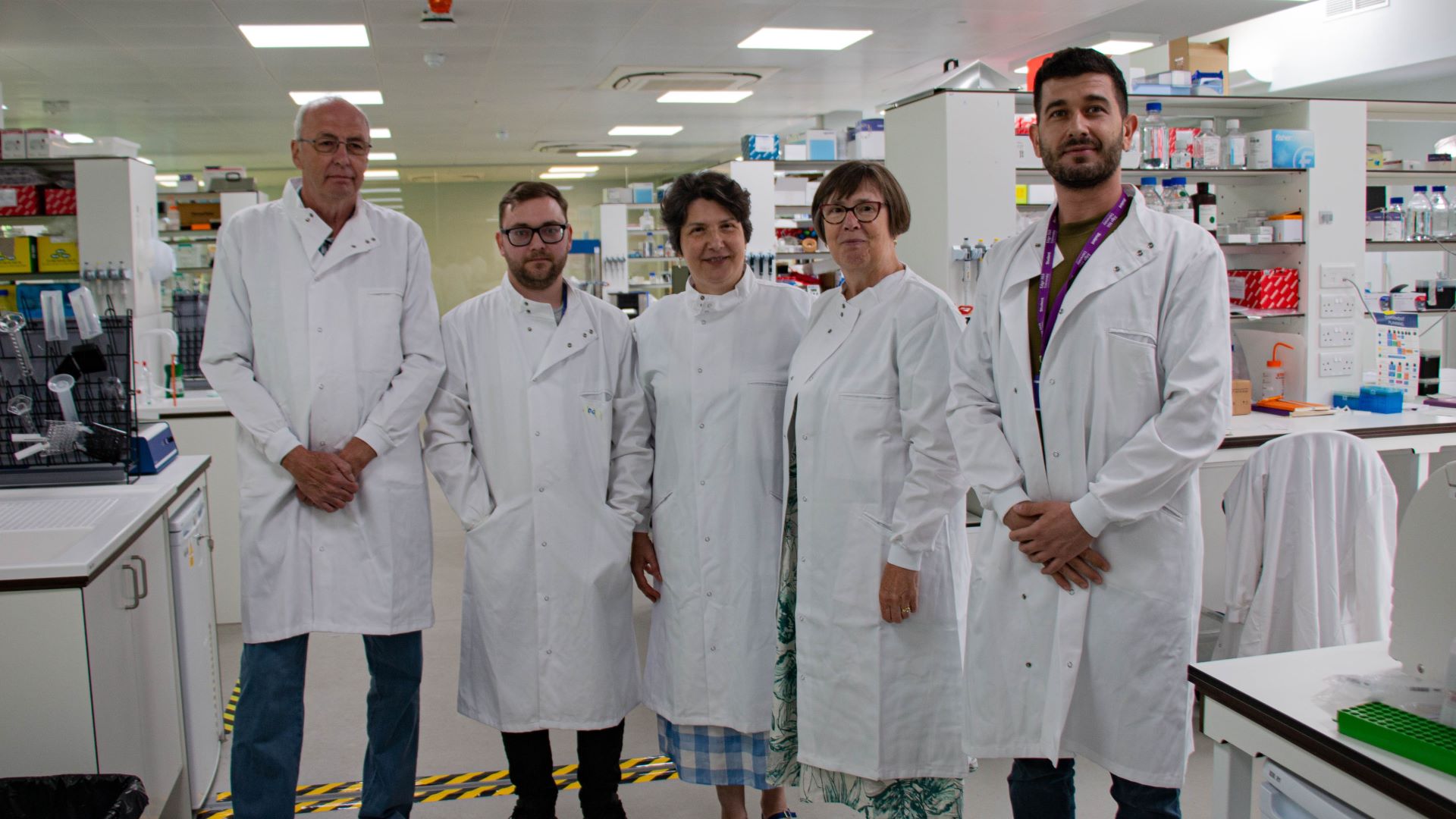 Macular degeneration research team stand together for a photo.