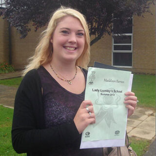 Maddison Barnes holding her BSc (Hons) Psychology dissertation