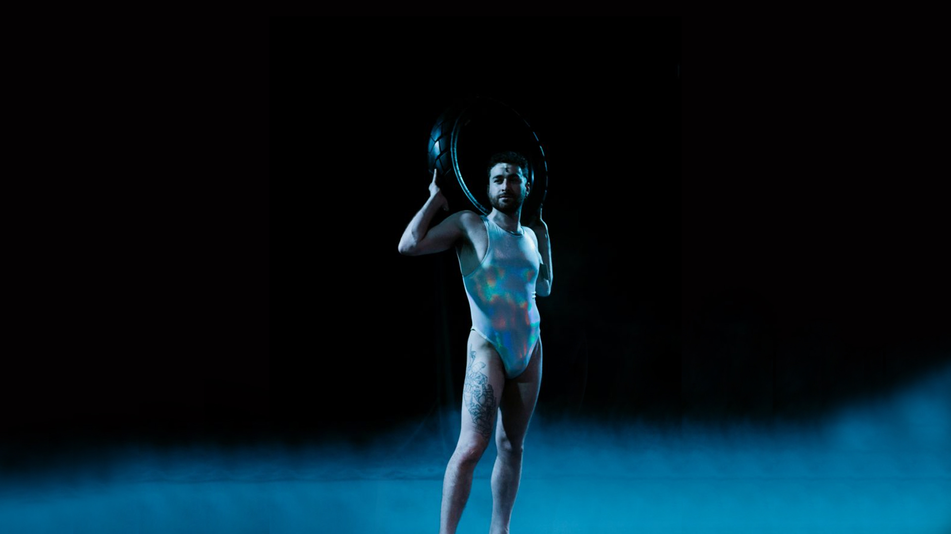 Action shot of a male dancer on stage during a performance.