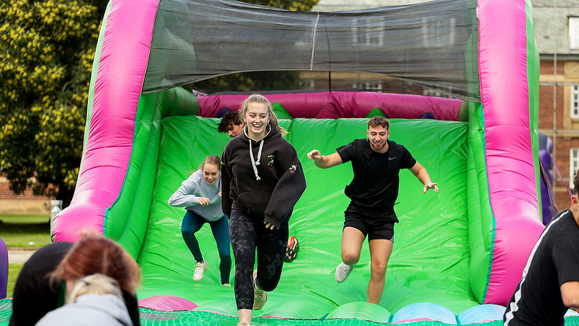 Students on an inflatable assault course during Induction Week